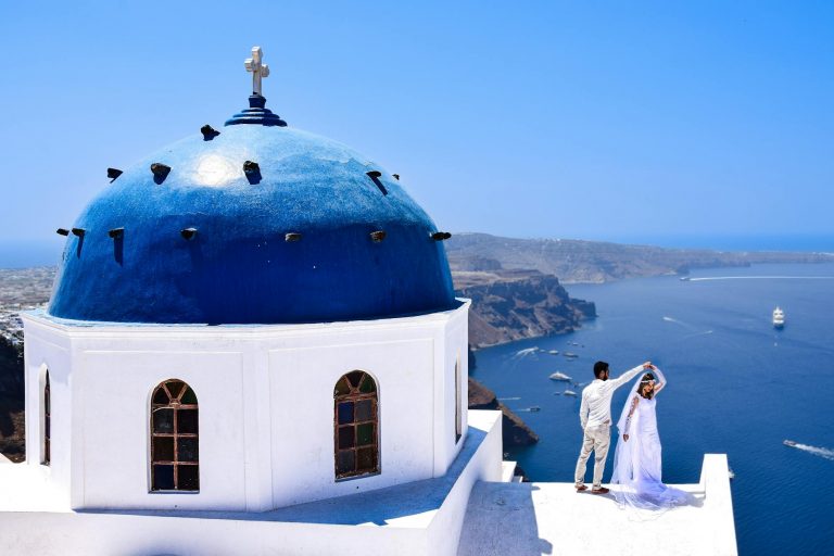 Beautiful destination wedding greece ceremony on Santorini terrace with caldera views