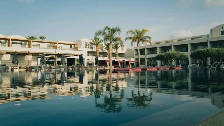 Best hotels Crete luxury infinity pool overlooking Elounda Bay with dramatic sunset views