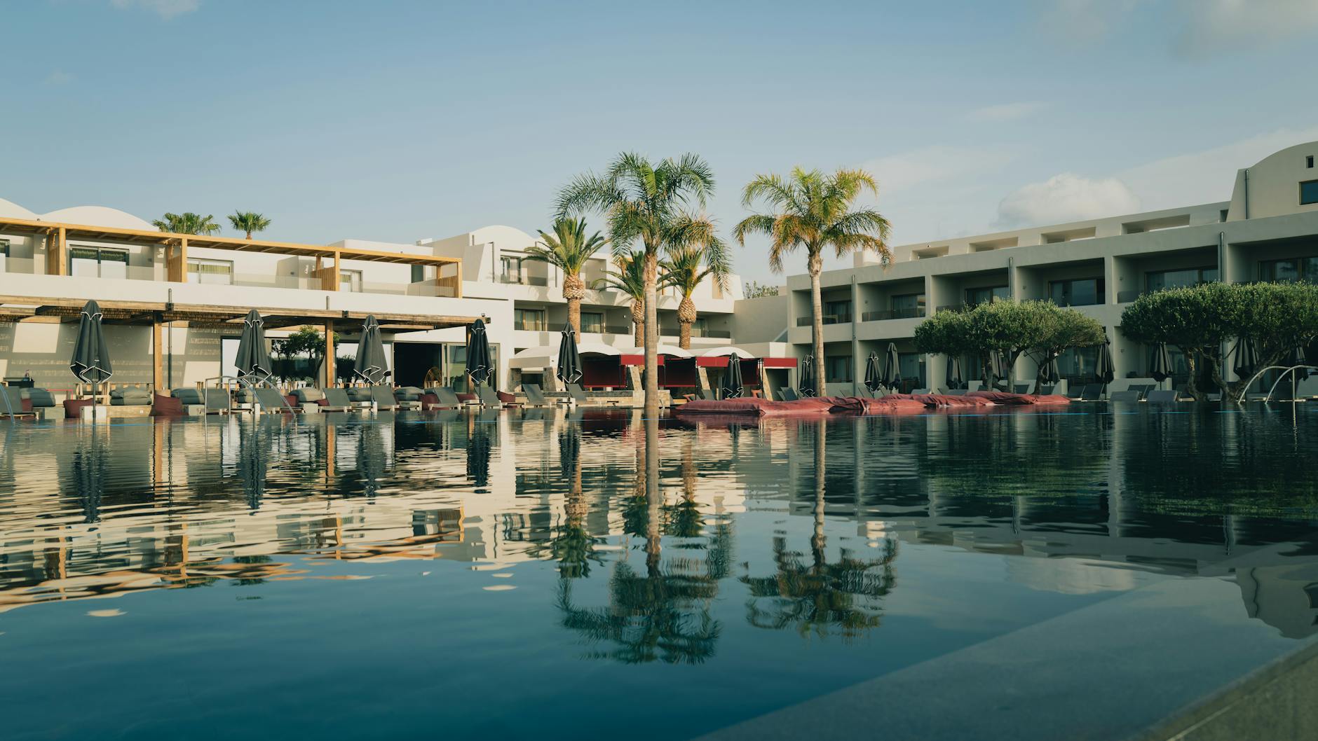 Best hotels Crete luxury infinity pool overlooking Elounda Bay with dramatic sunset views