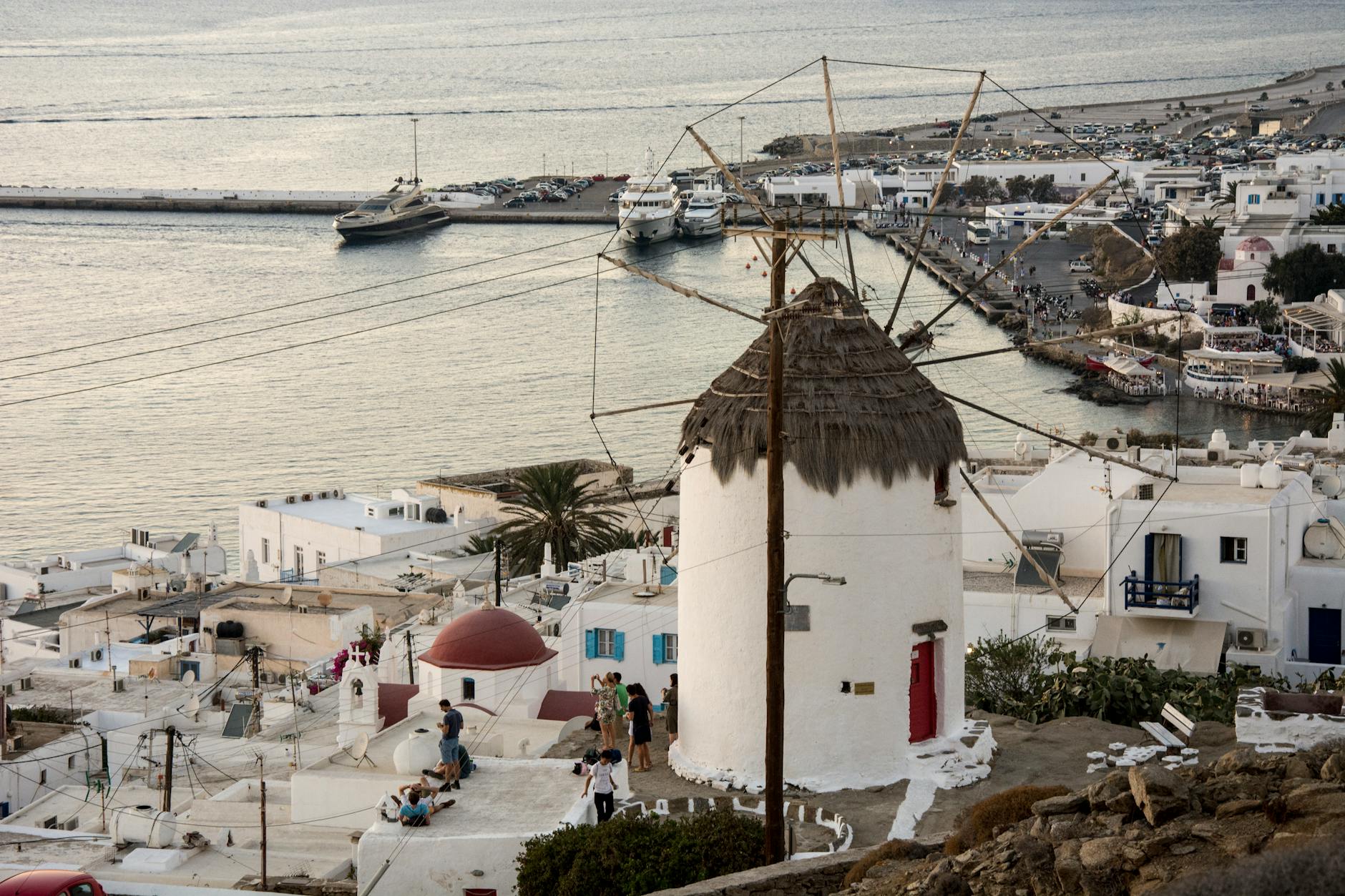 Families enjoying calm waters and organized beach at Ornos Bay Mykonos