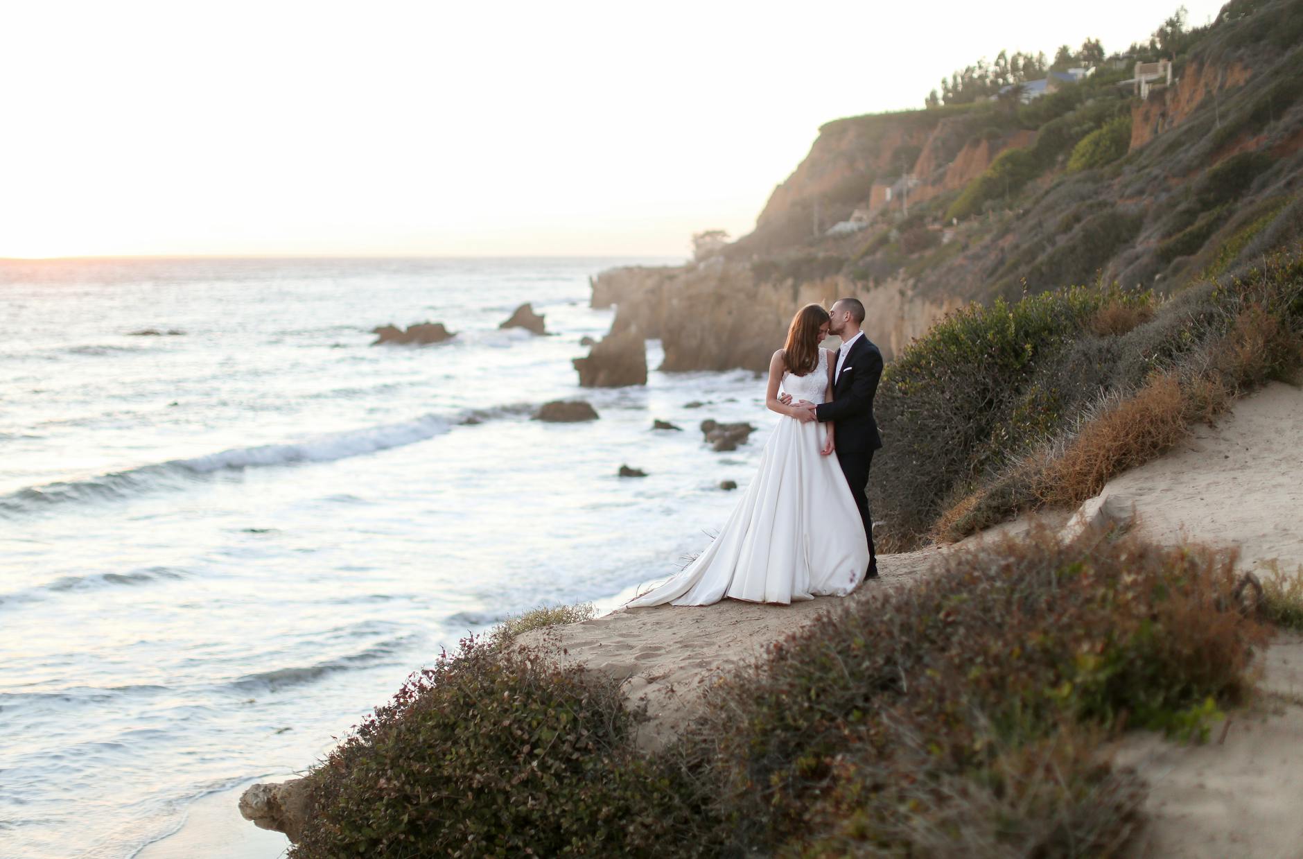 Luxury wedding setup at Canaves Oia Suites with caldera view and blue domed churches